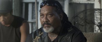 Movie still from “The Dark Horse” (2014), directed by James Napier Robertson – An older man with long hair and a beard; Close Up shot, Over the shoulder angle