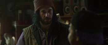 Movie still from “The Dark Horse” (2014), directed by James Napier Robertson – A man wearing a hat and jacket talking to a woman; Close Up shot, Over the shoulder angle