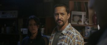 Movie still from “The Dark Horse” (2014), directed by James Napier Robertson – A man and a woman standing next to each other in a room; Close Up shot, Over the shoulder angle