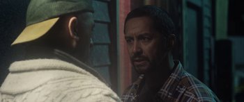 Movie still from “The Dark Horse” (2014), directed by James Napier Robertson – A man standing next to another man in front of a building; Close Up shot, Over the shoulder angle