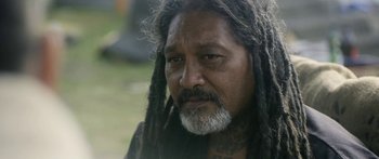 Movie still from “The Dark Horse” (2014), directed by James Napier Robertson – A person with dreadlocks; Close Up shot, Over the shoulder angle