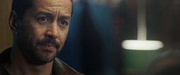 Movie still from “The Dark Horse” (2014), directed by James Napier Robertson – A man's face in a dark room; Close Up shot, Over the shoulder angle