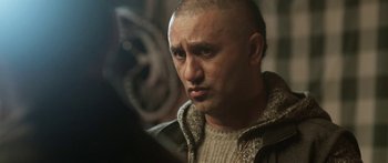 Movie still from “The Dark Horse” (2014), directed by James Napier Robertson – A man with a bald head looking into a mirror; Close Up shot, Over the shoulder angle