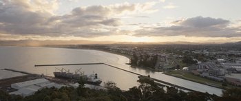 Movie still from “The Dark Horse” (2014), directed by James Napier Robertson – A view of a body of water with a ship in it; Extreme Wide shot, High angle
