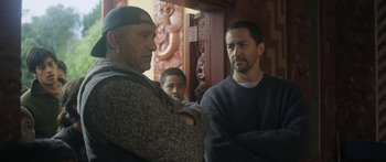 Movie still from “The Dark Horse” (2014), directed by James Napier Robertson – A group of men standing next to each other; Medium shot, Over the shoulder angle