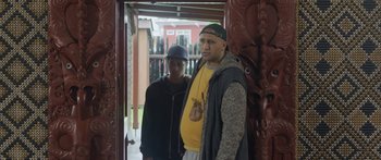 Movie still from “The Dark Horse” (2014), directed by James Napier Robertson – A man standing next to a woman in a doorway; Medium shot, Over the shoulder angle