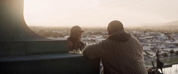 Movie still from “The Dark Horse” (2014), directed by James Napier Robertson – Two men are playing a game of chess outside; Medium shot, Over the shoulder angle