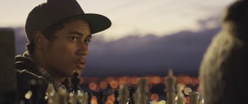 Movie still from “The Dark Horse” (2014), directed by James Napier Robertson – A man in a hat standing in front of a chess board; Close Up shot, Over the shoulder angle