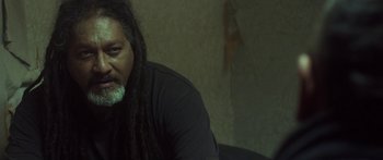 Movie still from “The Dark Horse” (2014), directed by James Napier Robertson – A person with dreadlocks; Close Up shot, Low angle
