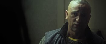 Movie still from “The Dark Horse” (2014), directed by James Napier Robertson – A man with bald head wearing a jacket; Close Up shot, Over the shoulder angle