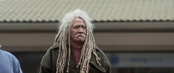 Movie still from “The Dark Horse” (2014), directed by James Napier Robertson – An older man with dreadlocks and a beard; Close Up shot, Low angle