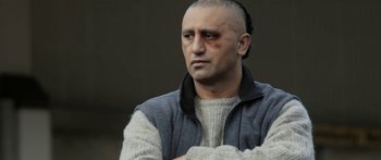 Movie still from “The Dark Horse” (2014), directed by James Napier Robertson – A man with a shaved head is looking at the camera; Close Up shot, Over the shoulder angle
