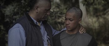 Movie still from “The Dark Horse” (2014), directed by James Napier Robertson – A man and a young man are looking at each other; Close Up shot, Over the shoulder angle