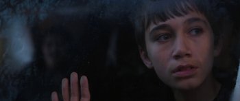 Movie still from “The Dark Horse” (2014), directed by James Napier Robertson – A young boy looking out of a window at night; Close Up shot, Low angle