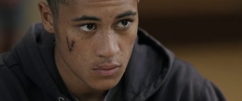 Movie still from “The Dark Horse” (2014), directed by James Napier Robertson – A young man with a bandage on his face; Close Up shot, Over the shoulder angle