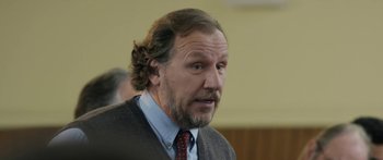 Movie still from “The Dark Horse” (2014), directed by James Napier Robertson – A person wearing a suit and tie; Close Up shot, Over the shoulder angle