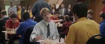 Movie still from “The Dark Horse” (2014), directed by James Napier Robertson – A young man is playing a game of chess; Close Up shot, Over the shoulder angle