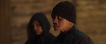 Movie still from “The Dark Horse” (2014), directed by James Napier Robertson – A man wearing a black hat and a woman wearing a black jacket; Close Up shot, Over the shoulder angle