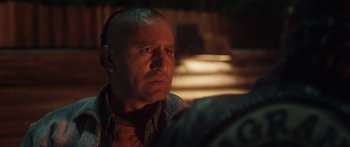 Movie still from “The Dark Horse” (2014), directed by James Napier Robertson – A man with a bald head is looking into the distance; Close Up shot, Over the shoulder angle