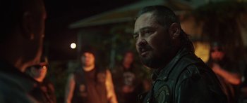 Movie still from “The Dark Horse” (2014), directed by James Napier Robertson – A man with a beard is standing in the dark; Close Up shot, Over the shoulder angle