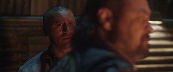 Movie still from “The Dark Horse” (2014), directed by James Napier Robertson – A man with a bald head is looking at the camera; Close Up shot, Over the shoulder angle