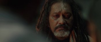 An old man with long hair and a beard