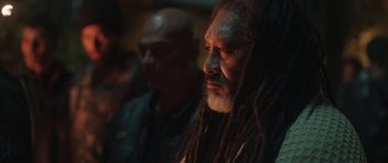 Movie still from “The Dark Horse” (2014), directed by James Napier Robertson – A man with dreads is looking into the distance; Close Up shot, Over the shoulder angle
