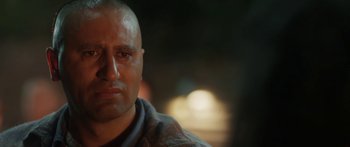 Movie still from “The Dark Horse” (2014), directed by James Napier Robertson – A person with a bald head; Close Up shot, Over the shoulder angle