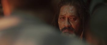 Movie still from “The Dark Horse” (2014), directed by James Napier Robertson – An old man with a beard and a mustache; Close Up shot, Over the shoulder angle