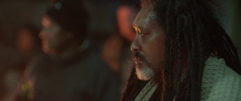 Movie still from “The Dark Horse” (2014), directed by James Napier Robertson – A person with dreadlocks; Close Up shot, Over the shoulder angle