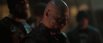 A man with a tattoo on his face and head