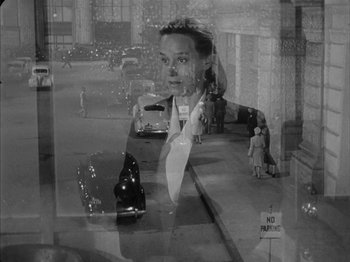 Movie still from “The Dark Mirror” (1946), directed by Robert Siodmak – A black - and - white photo of a woman looking out of a window; Medium shot, High angle
