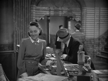 Movie still from “The Dark Mirror” (1946), directed by Robert Siodmak – A man and a woman are looking at papers; Medium shot, High angle