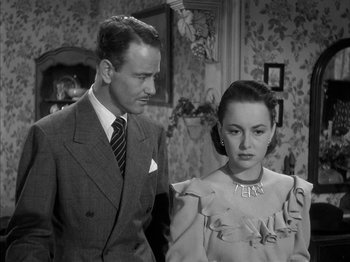 Movie still from “The Dark Mirror” (1946), directed by Robert Siodmak – A man and a woman standing next to each other in a room; Medium shot, High angle