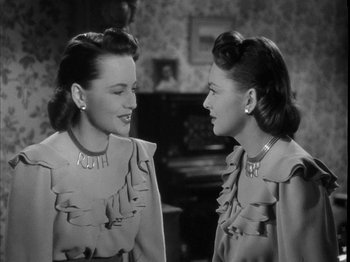 Movie still from “The Dark Mirror” (1946), directed by Robert Siodmak – Two young women are talking to each other; Close Up shot, High angle