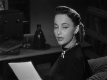 Movie still from “The Dark Mirror” (1946), directed by Robert Siodmak – A black - and - white photo of a woman reading a letter; Close Up shot, Over the shoulder angle