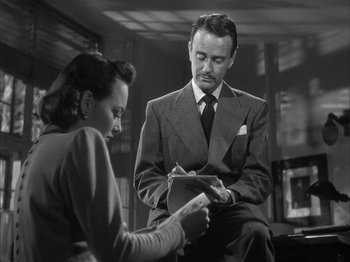 Movie still from “The Dark Mirror” (1946), directed by Robert Siodmak – A man and a woman sitting in front of each other; Medium shot, Low angle