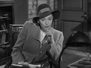 Movie still from “The Dark Mirror” (1946), directed by Robert Siodmak – A black and white photo of a woman wearing a hat; Close Up shot, Over the shoulder angle