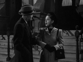 Movie still from “The Dark Mirror” (1946), directed by Robert Siodmak – A man and a woman are shaking hands outside; Medium shot, Low angle