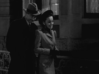 Movie still from “The Dark Mirror” (1946), directed by Robert Siodmak – A man and a woman walking down a street; Medium shot, High angle