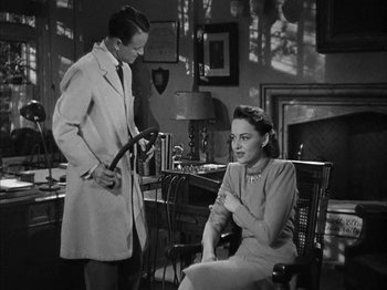 Movie still from “The Dark Mirror” (1946), directed by Robert Siodmak – A man and a woman are sitting in a room; Medium shot, High angle