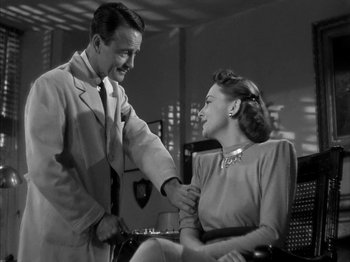 Movie still from “The Dark Mirror” (1946), directed by Robert Siodmak – A man and a woman are smiling at each other; Medium shot, Low angle