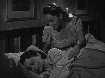 Movie still from “The Dark Mirror” (1946), directed by Robert Siodmak – An old photo of a woman and a man in a bed; Medium shot, High angle