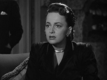 Movie still from “The Dark Mirror” (1946), directed by Robert Siodmak – An old black and white photo of a woman crying; Close Up shot, Over the shoulder angle