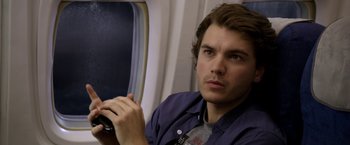Movie still from “The Darkest Hour” (2011), directed by Chris Gorak – A man sitting on top of an airplane holding a camera; Close Up shot, Over the shoulder angle