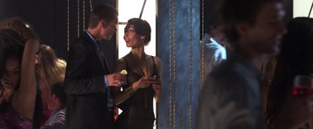 Movie still from “The Darkest Hour” (2011), directed by Chris Gorak – A man and a woman standing next to each other holding drinks; Medium shot, Over the shoulder angle