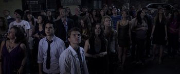 Movie still from “The Darkest Hour” (2011), directed by Chris Gorak – A group of people standing in front of a building; Wide shot, Low angle