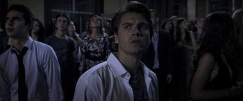 Movie still from “The Darkest Hour” (2011), directed by Chris Gorak – A man standing in front of a group of people; Close Up shot, Low angle
