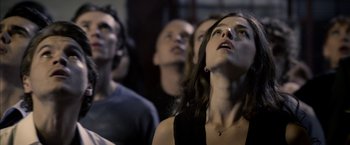 Movie still from “The Darkest Hour” (2011), directed by Chris Gorak – A group of young people watching something in the air; Close Up shot, Low angle