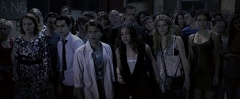 Movie still from “The Darkest Hour” (2011), directed by Chris Gorak – A group of people standing in a dark room; Medium shot, High angle